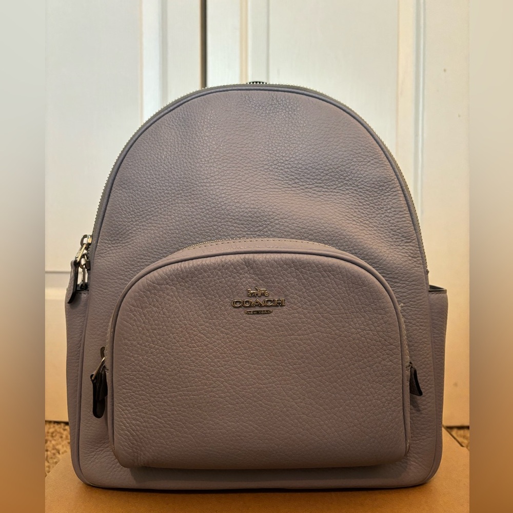 Coach Court Backpack. Front zip pocket, two side pockets, zip-top closure.